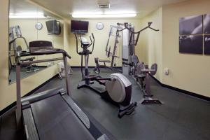 a gym with several tread machines in a room at Country Inn & Suites by Radisson, Germantown, WI in Germantown