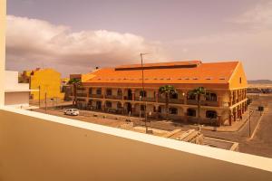 a large building with an orange roof on a street at Home sweet home in Santa Maria