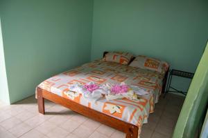 Carate的住宿－Ventanas Rio，一间卧室,床上放着鲜花