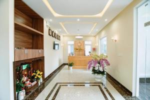 eine Lobby mit einem Kamin und Blumen darin in der Unterkunft Vân Dương hotel in Kon Von Kla