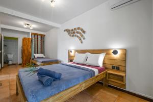 a bedroom with a large bed with blue sheets at Vert Ocean in Le Marin +28 photos