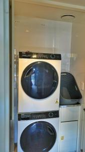 a washer and dryer sitting in a room at Wharf-view Waterfront Apartment in Darwin