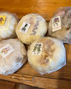a group of doughnuts with tags on them on a tray at irodori in Matsumoto