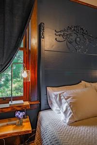 a bedroom with a bed and a window and a table at Charming Room in Capitol Hill - Foxglove Inn Rm 2 in Seattle
