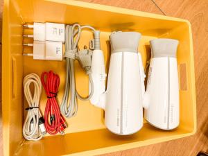 a drawer filled with white controllers and utensils at Yunseul- Garden House in the City with Korean Beauty in Seoul