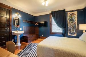a blue bedroom with a bed and a sink at Charming Room in Capitol Hill - Foxglove Inn Rm 3 in Seattle