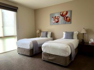 a hotel room with two beds and a window at Wild Cattle Creek Estate in Wandin Yallock