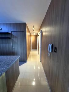 a hallway of a kitchen with a phone on the wall at Cozy 2 Bedroom Apartment. in Santo Domingo