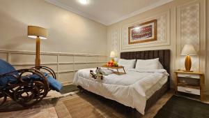 a bedroom with a bed and a table with flowers on it at Peaceful in Heart of El mansoura in Mansoura