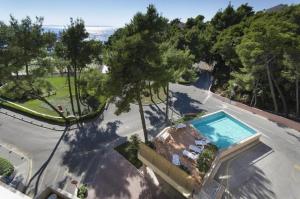 an aerial view of a house with a swimming pool at Apartments with a swimming pool Podstrana, Split - 20098 in Podstrana