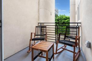 two chairs and a table on a balcony at Luxurious 2BR Condo in K-town w/ Private Balcony! in Los Angeles