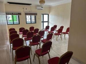 a room with a bunch of chairs in it at Checkers Suite & Apartments in Abuja