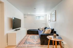 a living room with a couch and a tv at Pet-Friendly Denver Home 2 Blocks to City Park! in Denver