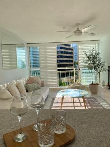 a living room with two wine glasses and a table at Condor Surfers - Hosted by Coastal Letting Company in Gold Coast