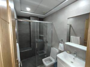 a bathroom with a shower and a toilet and a sink at Hotel Residence Ramsis in Nador +30 photos