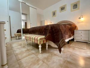 a bedroom with a large bed and a mirror at Primavera in Costa Del Silencio