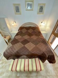 a bed with a blanket on the floor in a room at Primavera in Costa Del Silencio