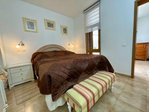 a bedroom with a bed with a blanket on it at Primavera in Costa Del Silencio