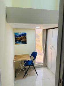 a desk and a chair in a room with a window at Private Room in beautiful Appartment in Dubai