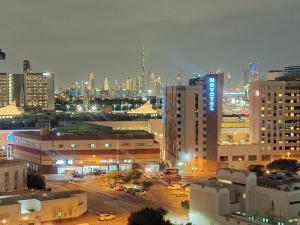 a view of a city at night with at Private Room in beautiful Appartment in Dubai