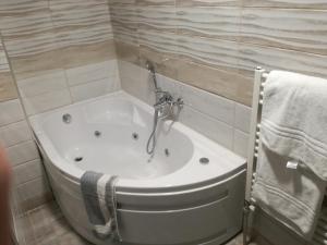 a bath tub with a faucet in a bathroom at Four Seasons Hotel in Trílofon