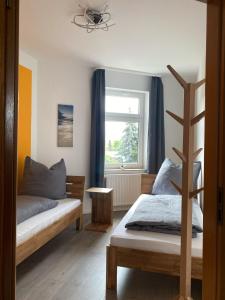 a bedroom with two beds and a window at FeWo „Lucy“ 5 Personen, zentrale Lage, Parkplatz in Dessau