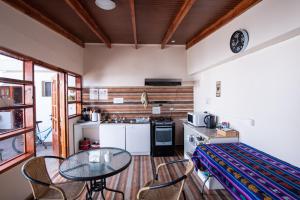 a small kitchen with a table and chairs in a room at Hostal Belen in San Pedro de Atacama