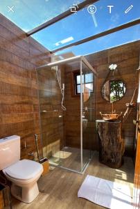 a bathroom with a shower and a toilet and a sink at Lambú Ecoturismo in Cidade Ocidental