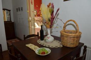 
a table with a basket of fruit and a bottle of wine at Vouni Lodge in Vouni
