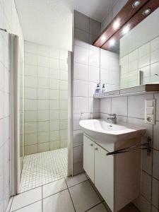 a bathroom with a sink and a shower at FEWO Elsa in Oberstaufen