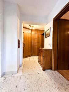 an empty hallway with a wooden door and a room at FEWO Elsa in Oberstaufen