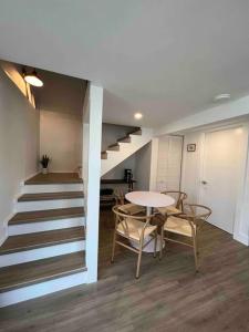 a room with a staircase and a table and chairs at La Casita in Miami