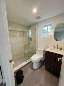 a bathroom with a shower and a toilet and a sink at La Casita in Miami +9 photos