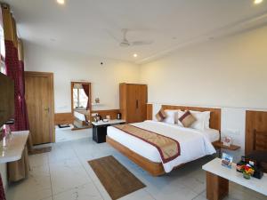 a bedroom with a large bed in a room at MGM Whispering Wind's Yelagiri in Yelagiri