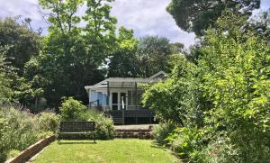 a small house in the middle of a garden at Nagoondie Studio in Healesville