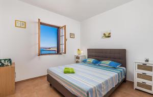 a bedroom with a bed with a view of the ocean at Amazing Apartment In Jablanac in Jablanac +32 photos
