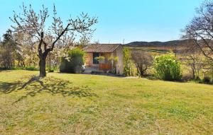 a small house in the middle of a grass field at Le Gite Du Bastidon in La Tour-dʼAigues