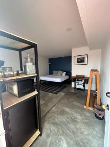 a living room with a bed and a microwave at Bugambilias 203 Oaxaca in Oaxaca City