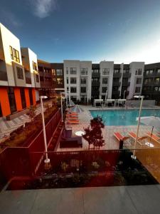 a view of an apartment complex with a swimming pool at Alameda Bay Living in Alameda