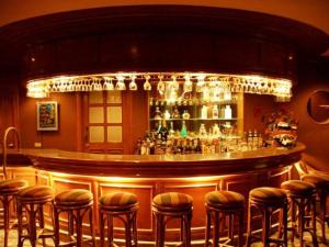 a bar at a restaurant with stools at Garden Orchid Hotel & Resort Corp. in Zamboanga