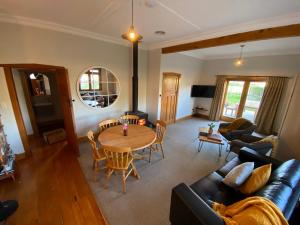 a living room with a table and a couch at Makoura Lodge in Apiti