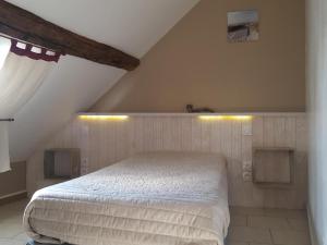 una camera da letto con letto bianco in mansarda di Gîte 18ème avec jardin, jeux, et ateliers cuisine près de l'Abbaye de Pontlevoy. - FR-1-491-349 a Pontlevoy Altre 10 foto