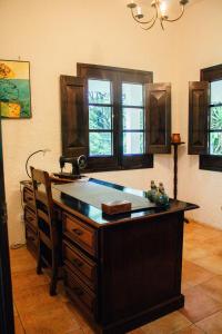 a kitchen with a island in a room with windows at Finca Ana Isabel 