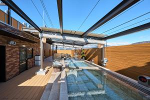 a swimming pool on the roof of a building at Sauna & Capsule Hotel Rumor Plaza in Kyoto