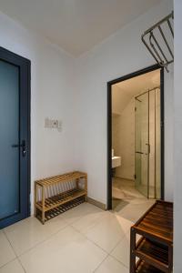 a room with a bathroom with a door and a mirror at HOLO BEN THANH SAIGON Serviced HomeStay in Ho Chi Minh City