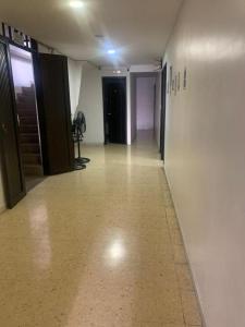 an empty hallway of a building with a door and a hallwayngthngthngthngth at Hotel La Fresa L&G in Pereira