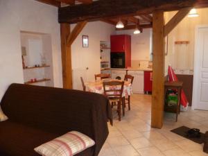 a kitchen and dining room with a table and a kitchen with a tableablish at Charmante maison avec jardin clos à Cour-Cheverny, animaux acceptés - FR-1-491-387 in Cour-Cheverny
