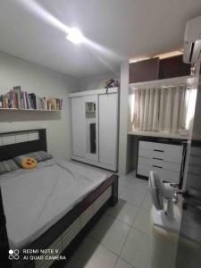 a bedroom with a large bed and a sink at Apartamento Caruaru PE bairro Mauricio de Nassau in Caruaru