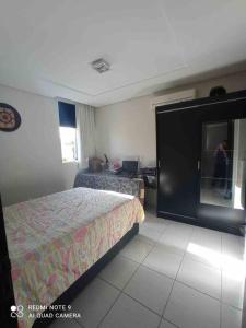 a bedroom with a bed and a flat screen tv at Apartamento Caruaru PE bairro Mauricio de Nassau in Caruaru +25 photos