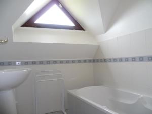 een badkamer met een dakraam, een wastafel en een bad bij Gîte Cour-Cheverny, 4 pièces, 6 personnes - FR-1-491-407 in Cour-Cheverny